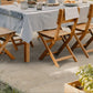 Aurum Travertine Outdoor Porcelain Paving Slabs under outdoor wooden chairs and table. 