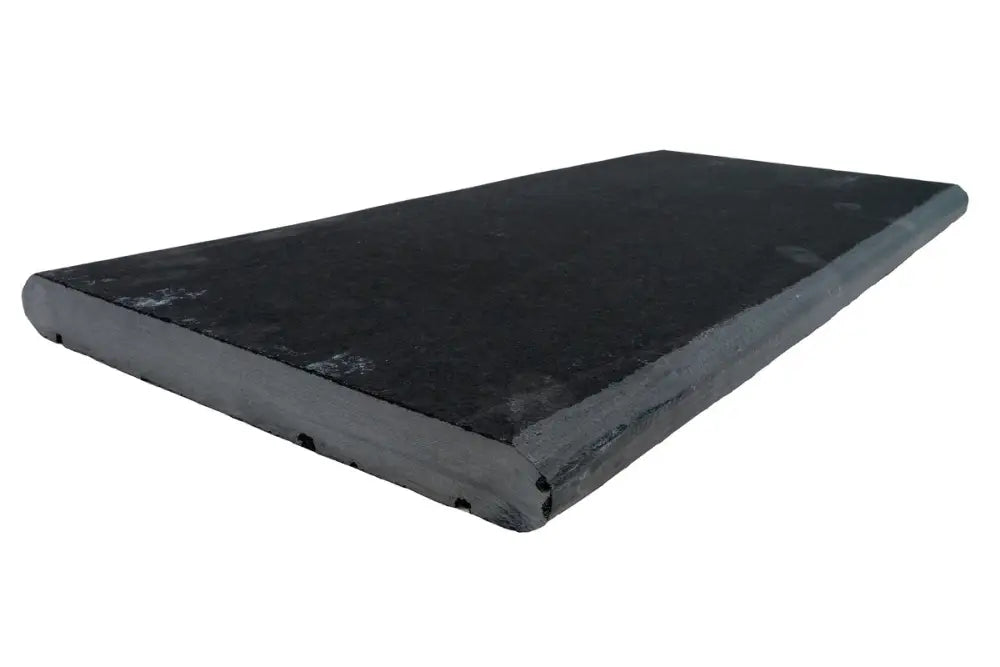 Black limestone coping stone with a 60cm x 30cm size and bullnosed edge.