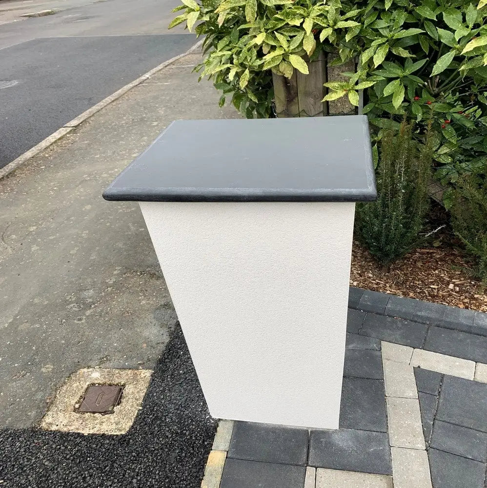 Black pier cap on small pillar.