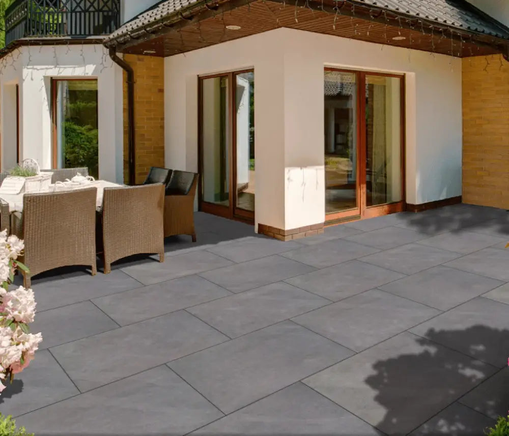 Image of a completed outdoor space paved with Ardesia Grey Outdoor Porcelain Paving Slabs. The sleek grey finish and clean-cut sawn edges create a stylish and sophisticated look, perfect for any outdoor area.