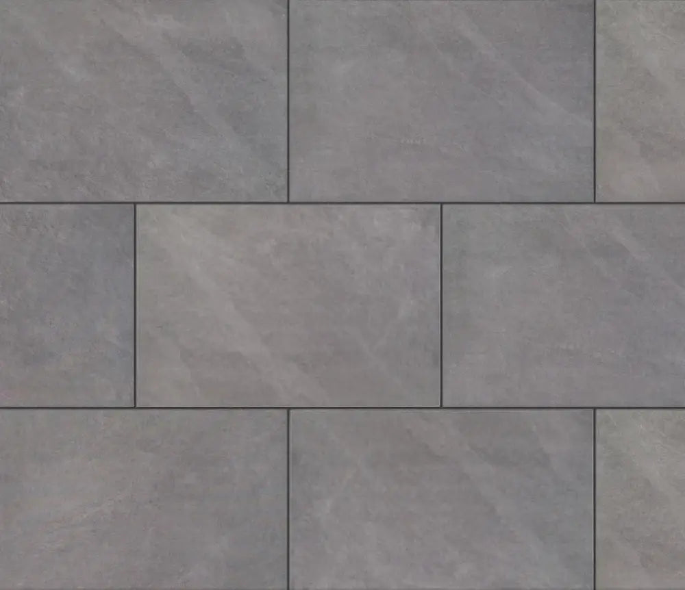 Image of multiple Ardesia Grey Outdoor Porcelain Paving Slabs arranged in a sophisticated pattern. The clean-cut sawn edges ensure a seamless and polished finish, making it an ideal choice for outdoor spaces.