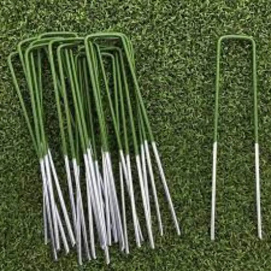 Artificial grass pins - a bag of 10. Grass pins laying on top of artificial grass. Ideal for securing turf in place.