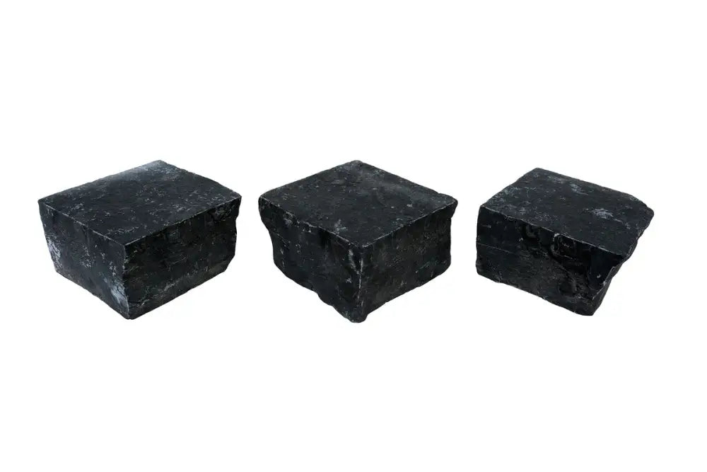 3 black limestone cobbles on white background.