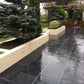 Black limestone paving slabs laid in a brick pattern for outdoor flooring.